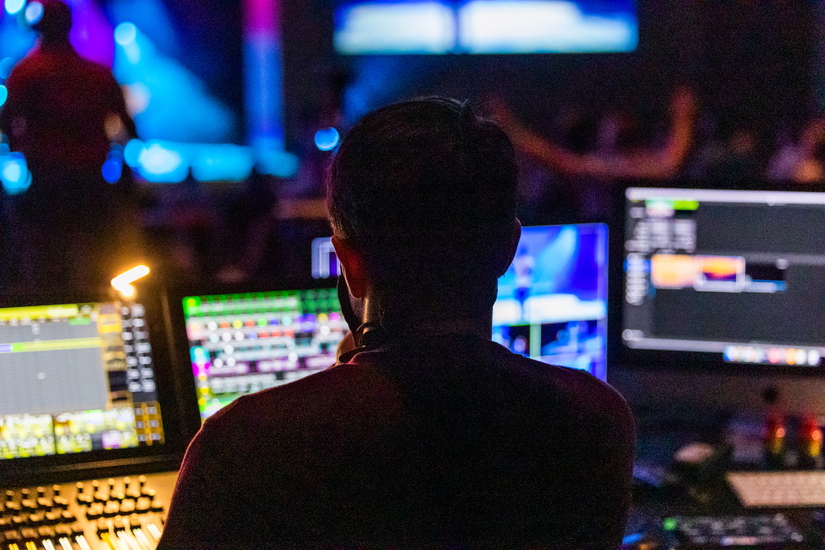 A Man in Front of Computer Screens